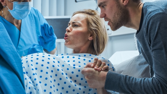 White woman in labor with husband